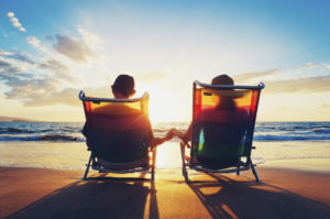 couple holding hands on beach during sunset
