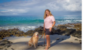 Woman on beach with dog on leash